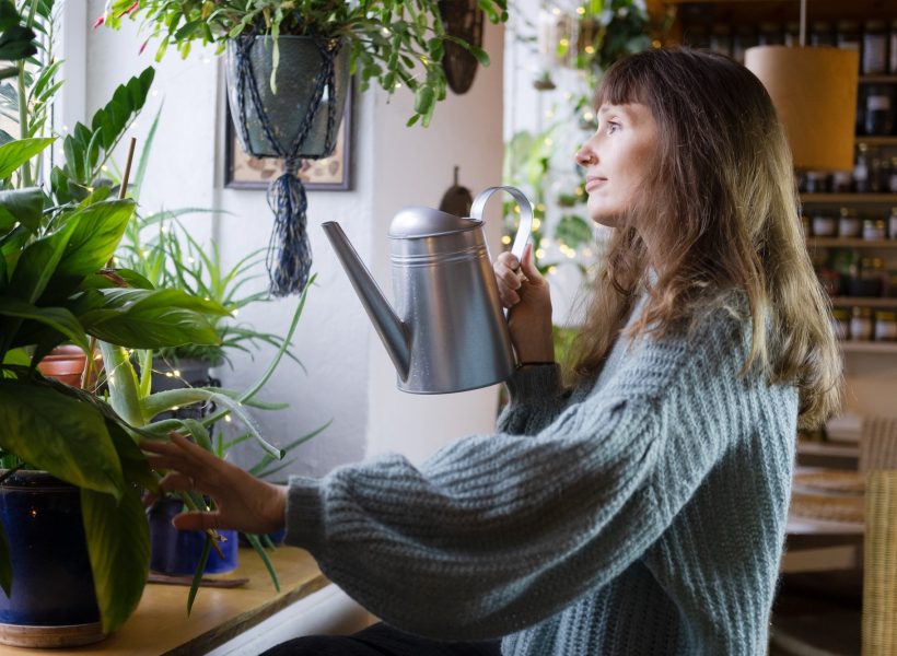 woman-takes-care-of-indoor-plants-at-cozy-home-.jpg